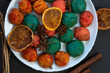 Colorful homemade cookies, spices and candied fruits.The view from the top. Star anise and dried orange and cinnamon.. The concept of home-made winter food