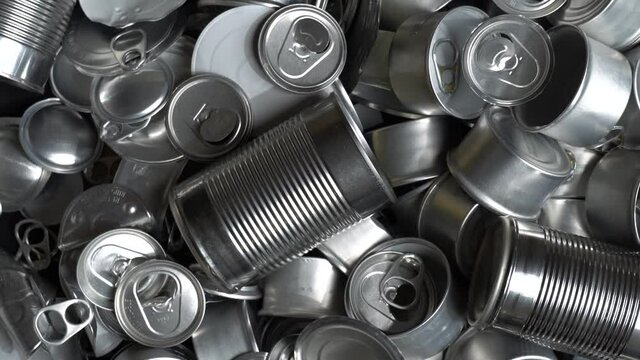 Metal tins, cans and jar garbage from household on the table. City home trash made of aluminum. Empty used, food and drink steel packaging waste and scrap discarded sorted and ready to recycle.
