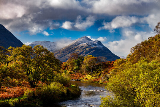 Cloudy sky, river and snowy mountains in Connemara, County Galway, Ireland