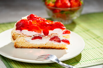 piece of cake on white plate with strawberries