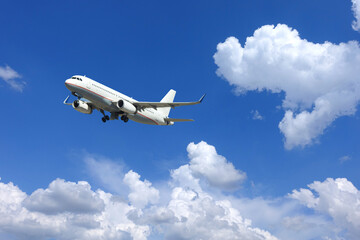 Fototapeta na wymiar Zoom photo of passenger airplane taking off in deep blue sky and beautiful clouds