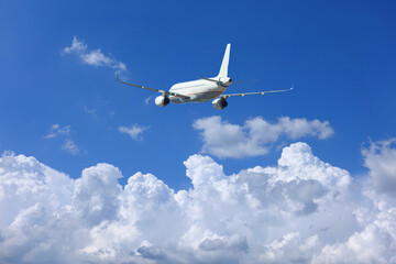 Zoom photo of passenger airplane flying in deep blue sky and beautiful clouds