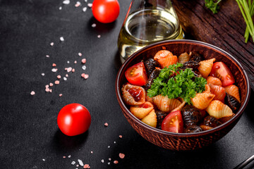 Delicious fresh paste with tomato sauce with spices and herbs on a dark background