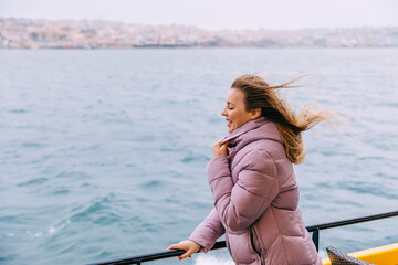 girl sitting on a ship while traveling by boat. vacation, city t