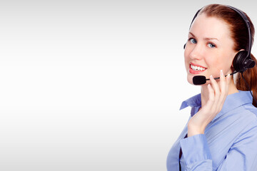 Pretty woman with headset on her head against a grey background with copyspace