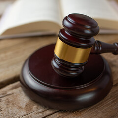 Macro shot view of judge's gavel on wooden table on Constitution background. Law theme concept....