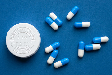 Blue and White Medication Capsules with Bottle Cap