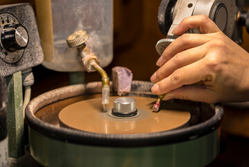 Faceting process of the white feldspar stone to the round brilliant cut.