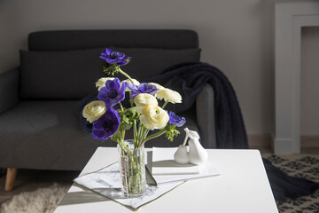 Bouquet of white ranunculus and blue anemone on a white background.