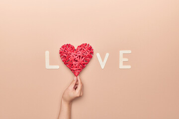 hand grabbing heart decoration in love phrase for Valentine