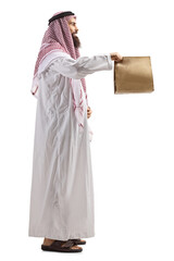 Saudi arab man holding a paper bag with takeaway food