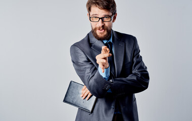 Business man with a coin in his hands and a puzzled look gesticulate with his hands Bitcoin...
