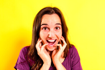 Portrait of a young woman with scared and shocked expression with surprise, fear and excited face, on isolated background.