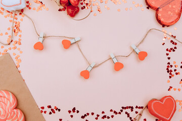 Red hearts on a rope with beads, on a white wooden background. Space for text, space for copying. Valentine's Day concept
