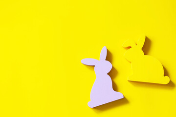 Happy Easter design. Minimal the Easter rabbits on Illuminating Yellow Color of the year 2021. Top view flat lay background.