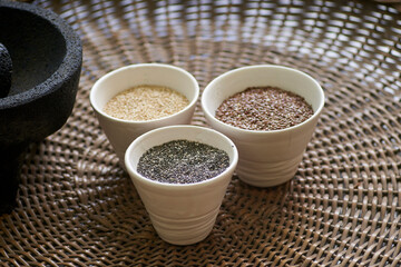 Various seeds and health grains arranged in bowls