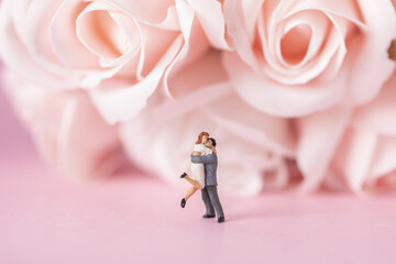 Selective focus shot of a hugging couple miniature figurine