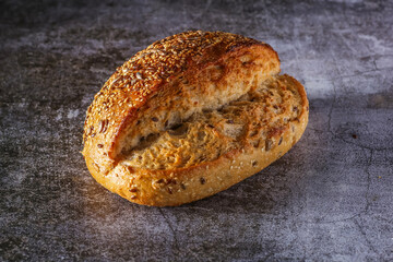 Assortment of baked bread on wooden table background Fresh fragrant bread on the table. Food concept.