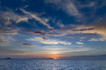 beautiful horizon on the ocean with dramatic clouds in the sky at sunset