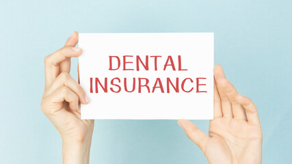 DENTAL INSURANCE message on the card shown by a hands, vintage tone