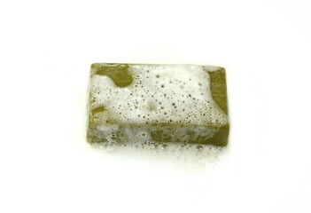 Olive Soap bar with foam isolated on white  background. Wet bar of soap. Antivirus. Coronavirus (CoV). Fighting virus.