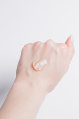 drop of transparent face gel on the girl's hand on a white background