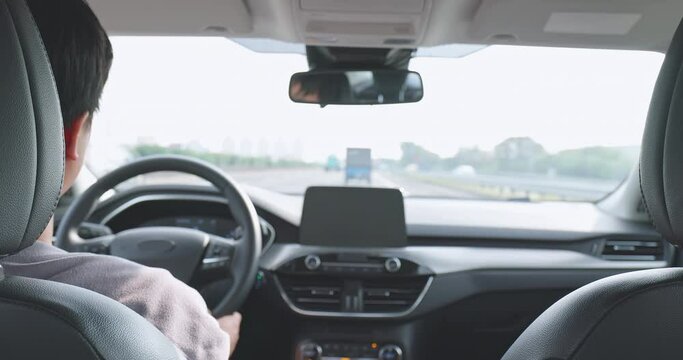 asian man driving car