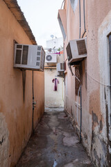 Fototapeta na wymiar Alley way in Muscat, Oman with a dress on a hanger in the middle