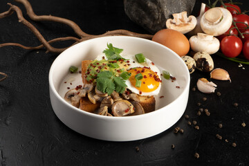 Toast with avocado, mushrooms and egg. Hot breakfast of brown bread, vegetables, mushrooms and a fried egg with herbs.