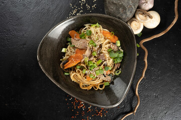 Udon noodles with duck. Hot main Asian dish made from pasta, poultry, vegetables, herbs and sesame seeds.