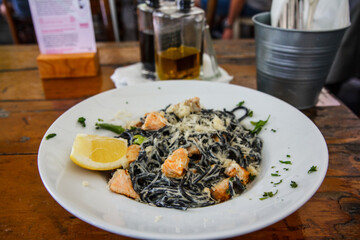 Black spaghetti pasta  with salmon, and cheese  in  sauce