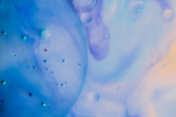 beautiful background of paint bubbles floating on water with mix of oil colors