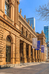 Building of the stock exchange in Frankfurt with flags above entrance. brown colored historical...