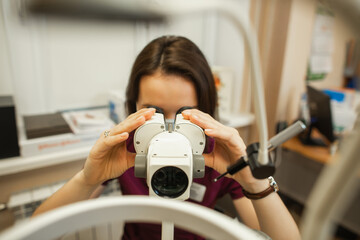 Optometrist checking eye with a slit lamp, close up.