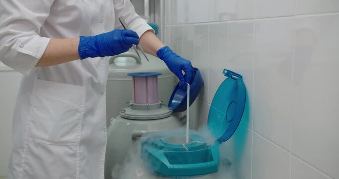 Young Woman Laboratory Assistant In Mask Is Working In DNA Laboratory With Cryostat