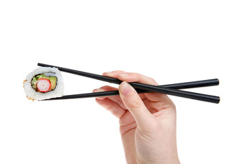 Close up on female caucasian hand holding black chop sticks with one California roll sushi, isolated on white.