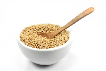 wheat grains in white bowl isolated on white background. 