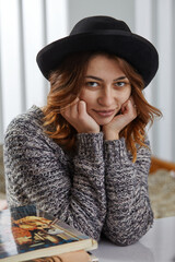 Fashion portrait pretty sweet young woman wearing a black hat 