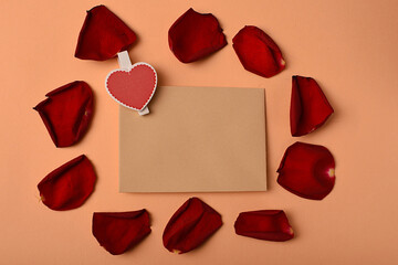 An envelope surrounded by rose petals and a heart. Symbol of love and romance