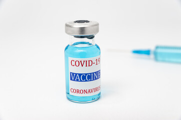 Medical concept - COVID-19 vaccine vial and disposable syringe. Isolated on white background. Copy space