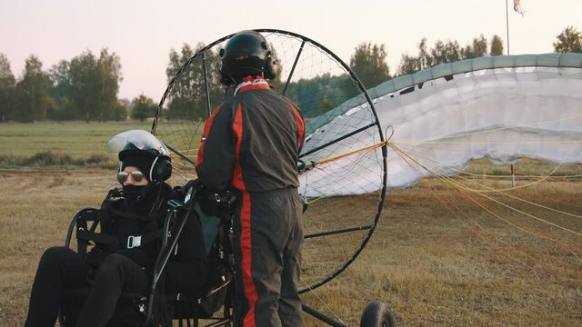 Tandem Paramotor gliding. Preparing paramotor to take off, adjusting of the parachute. High quality 4k footage