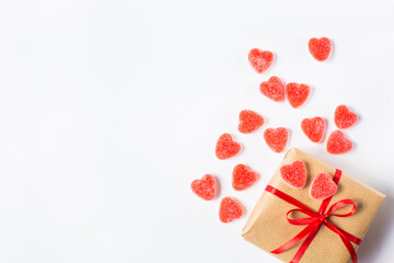 Valentine's day gift with a red ribbon decorated with and a little hearts are on a white background. Free space for text.