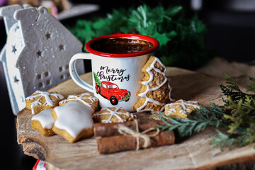 Homemade cookies and retro metal coffee cup on wooden desk. Christmas food decoration concept