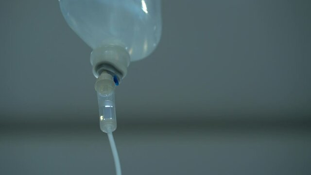 Closeup of IV drip in hospital, Intravenous saline solution, IV fluid loading dose. 0.9% NSS drip.