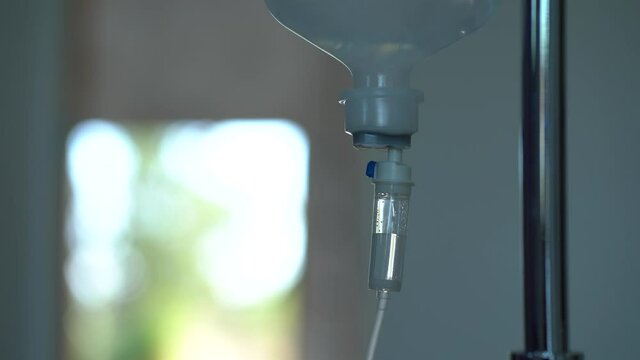 Closeup of IV drip in hospital, Intravenous saline solution, IV fluid loading dose. 0.9% NSS drip.