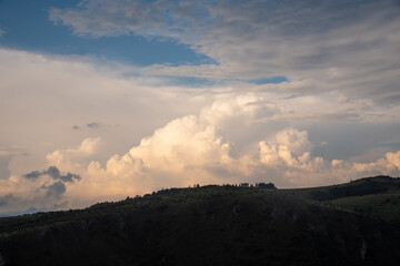 Scenic canyon view of meanders on the river Uvac, on the Zlatar Mountain with beautiful sunset with dramatic and fluffy white clouds and sky in background. Uvac is a special nature reserve in Serbia.