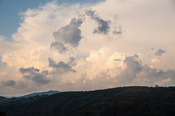 Scenic canyon view of meanders on the river Uvac, on the Zlatar Mountain with beautiful sunset with dramatic and fluffy white clouds and sky in background. Uvac is a special nature reserve in Serbia.
