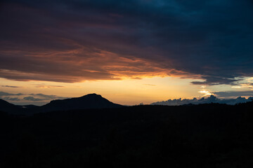 Scenic canyon view of meanders on the river Uvac, on the Zlatar Mountain with beautiful sunset with colorful and dramatic clouds and sky in background. Uvac is a special nature reserve in Serbia.