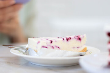 Blueberry Cheesecake is placed on a white plate in the cafe.