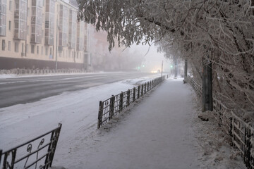 A path through snow-covered trees in Yakutsk city - 403928081